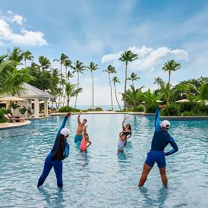 Family doing aqua aerobics in the main pool.
