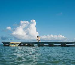 A couple strolling along a pier.